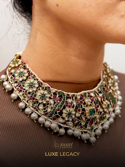 The soul of my craft is in the details. This close-up reveals the intricate floral work of a luxe legacy choker, where each polki stone and colored gem is meticulously set to create a tapestry of light and color.