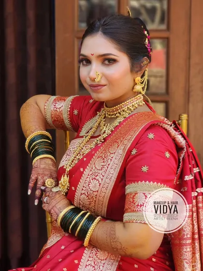 A portrait of our bride Priya, looking elegant in her red bridal saree. My artist Vidya created a classic Maharashtrian look with a traditional updo and gold jewellery.
