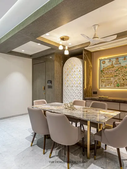 Another view of the culturally rich dining space, showing the intricate carved panel with gold inlay. This element serves as a beautiful backdrop and adds a layer of traditional elegance to the modern setting.