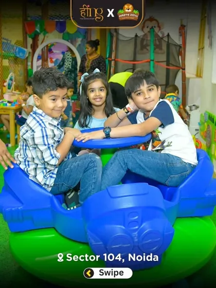 Friends taking a spin on the blue airplane-themed merry-go-round. It's a popular spot for group fun and making new friends at a party.