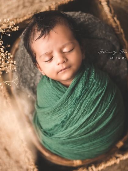 Wrapped in a soft, earthy green swaddle, this newborn is the picture of tranquility. I use a variety of high-quality wraps to ensure your baby is both comfortable and beautifully styled.