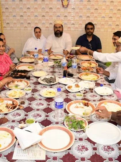 Guests enjoying a meal together at one of our long dastarkhwan setups. This seating arrangement is perfect for larger groups and fosters a wonderful sense of community.
