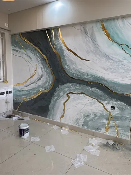 A work-in-progress shot of a granite mural, showing the scale and the materials used to achieve this fluid, stone-like effect. Even before it's finished, the impact is clear.