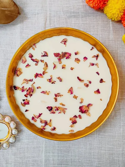 Another angle of the rose petal urli, showing the delicate texture of the petals scattered across the pure soy wax.