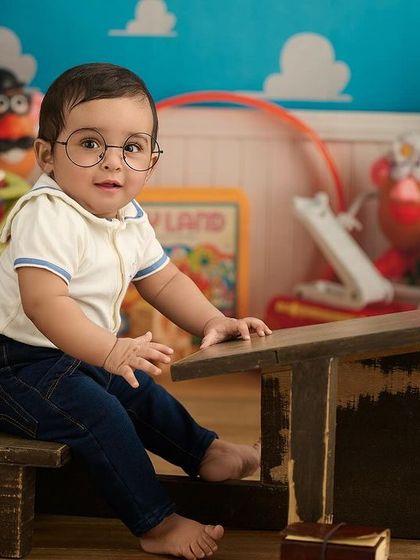 A studious look in our "Toy Story" room setup. The combination of the school desk and playful background creates a fun, narrative image.