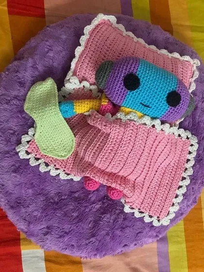 An overhead view of the Zeno doll sleeping with his handmade accessories. It was a fun challenge to create a whole little bed set for him.