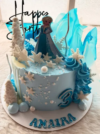 Let it go! This Frozen-themed cake is perfect for any little Elsa fan. I used shades of blue, edible snowflakes, and sugar shards that look like ice to create a winter wonderland.