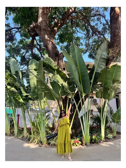 Never fully dressed without a smile and my cameras! Posing with some giant Bird of Paradise plants.