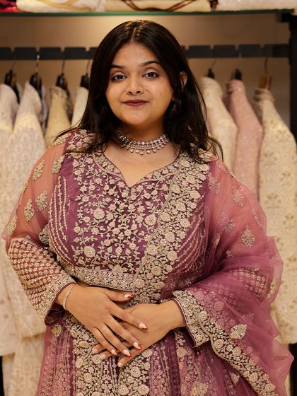Here is a closer view of the mauve-pink lehenga, highlighting the detailed silver threadwork on the blouse and skirt. It's a sophisticated piece for anyone wanting an elegant look.