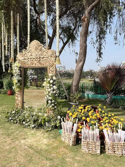 A wider view of the photo booth area, with baskets of traditional white umbrellas for guests to use.
