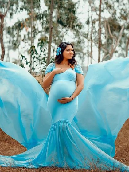 Taking the studio gowns outdoors for a magical effect. The flowing blue fabric of this dress looks incredible against the natural backdrop of the woods.