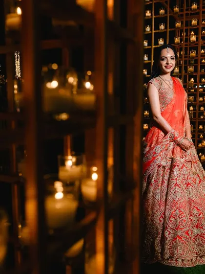 The bride posing against the candle wall. This decor piece is not just a backdrop but an experience, creating a warm and mesmerizing ambiance that guests love.