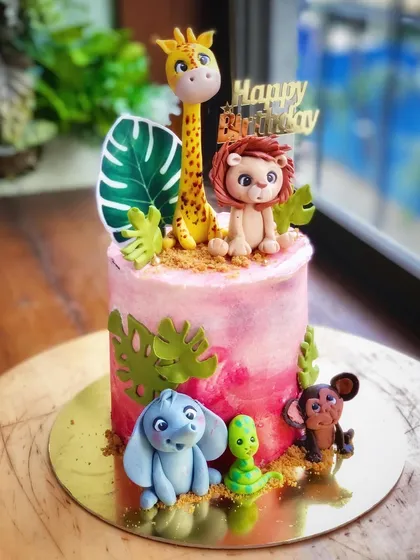 Kids' birthdays should be full of wonder. I specialize in creating vibrant, whimsical worlds, like this jungle-themed cake, featuring adorable, hand-sculpted fondant animals that bring a child's imagination to life.