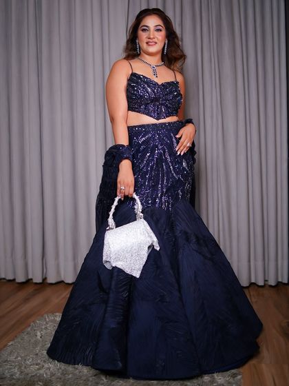 A confident pose in the full engagement outfit. The fishtail silhouette is a statement maker, perfect for a sister of the groom who wants to look special and celebratory.