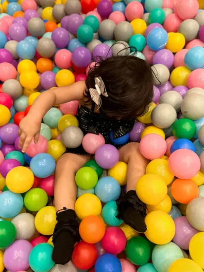 This little one is carefully selecting the perfect ball for her next game.