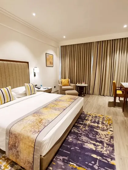 A premium room at Vivanta Bengaluru, where I blended calm tones and plush textures. The design features a custom bed runner and rug that add a splash of color and pattern to the otherwise neutral and restful space.