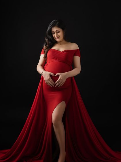 Making a heart shape with her hands on the baby bump. It's a simple, sweet gesture that says "I love you already."