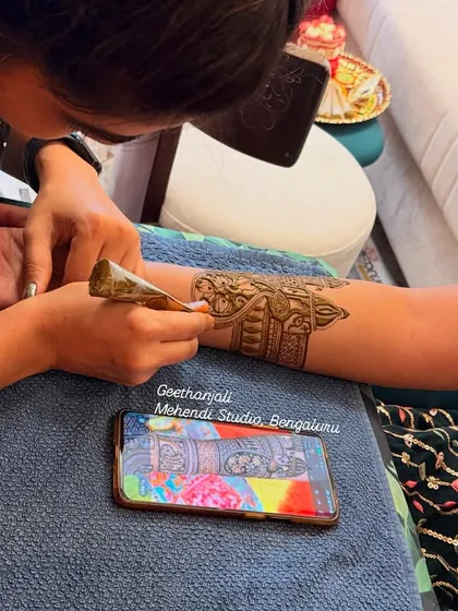 A close-up of my application technique. In my course, I focus on cone control to create clean lines and intricate details, like the elephant motifs seen here.