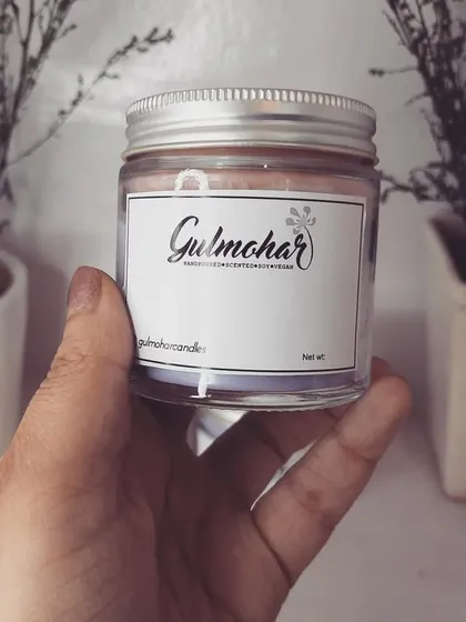 Holding up one of our 100ml glass jar candles. It's a great size for retail, offering a good burn time while remaining affordable.