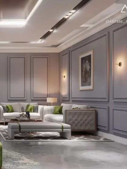 This formal sitting area showcases a cooler, more stately color scheme with grey paneled walls and marble flooring. The design uses classic furniture shapes and a grand chandelier to create an atmosphere of timeless elegance.