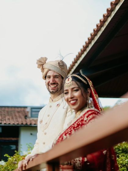 A joyful, smiling portrait of the couple, their happiness shining through.