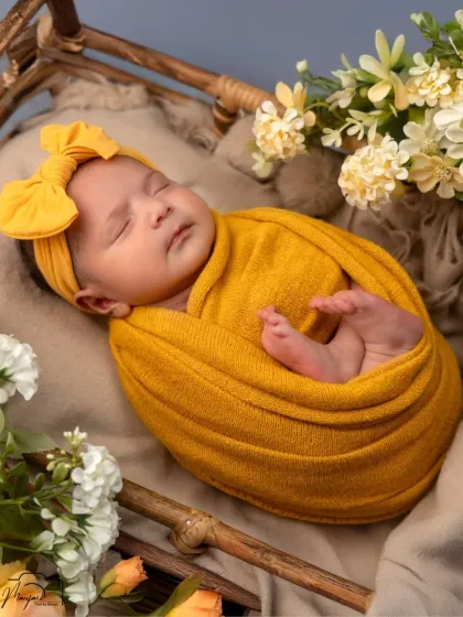 A bundle of sunshine. This newborn wrapped in a bright yellow swaddle looks so peaceful and content.