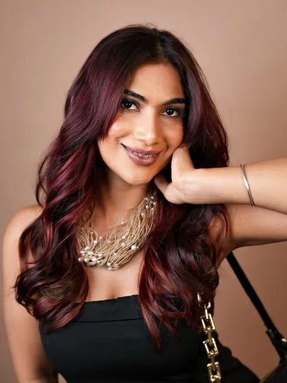 Beyond brunettes, we specialize in creating custom, vibrant colors. This look features a rich crimson balayage, expertly blended to create a fiery yet elegant effect with seamless transitions from root to tip.