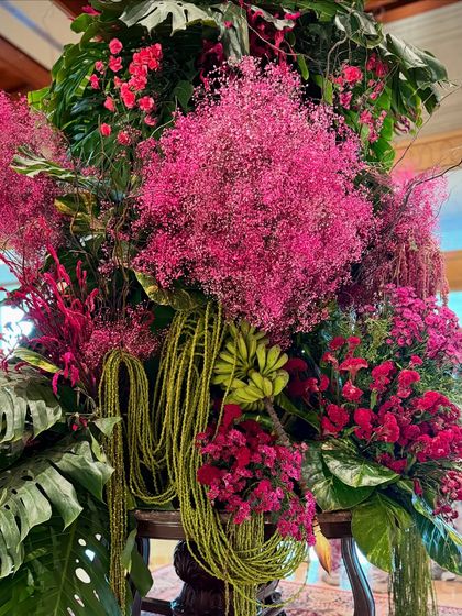 Another detail of the lush composition, where different species of flowers and foliage are layered to create a rich, dense, and vibrant display.