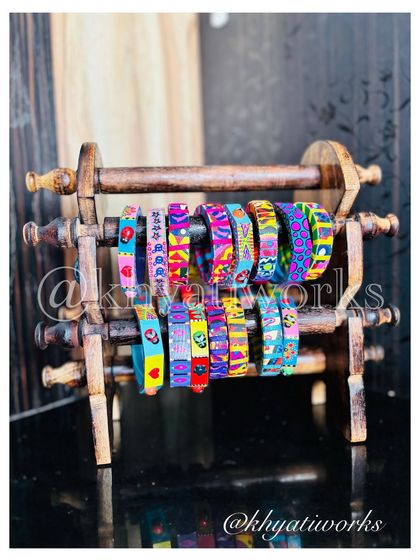 A collection of my slimmer, fabric-wrapped bangles. Each one features a different print of my original artwork, making them perfect for stacking.