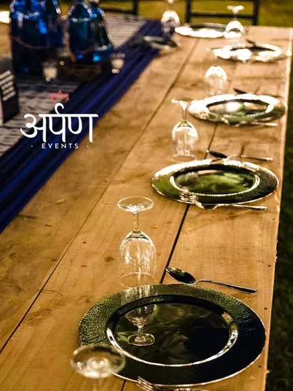A close-up of the elegant table setting for a wedding cocktail night, featuring silver charger plates and fine glassware that reflect our attention to detail.