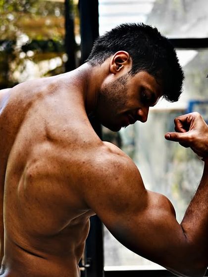 Jet Set Go. A shot of my back and bicep definition, a result of years of consistent, natural training.