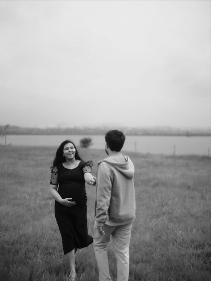 A beautiful black and white "follow me" shot, where she leads him by the hand with a smile. The focus is on their connection and the journey they are on together.