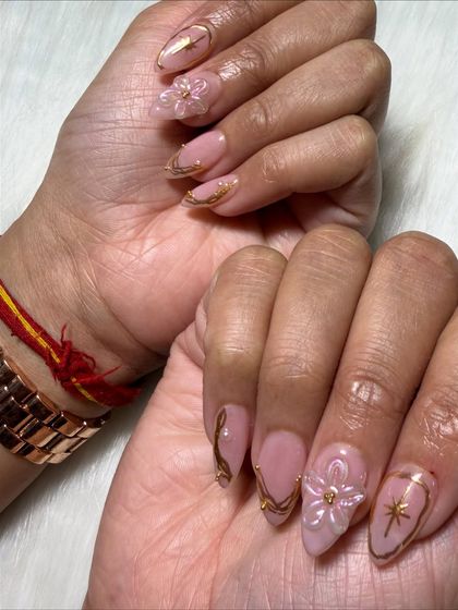 An artistic shot showing the side profile of the 3D flowers and the curve of the nail extensions.