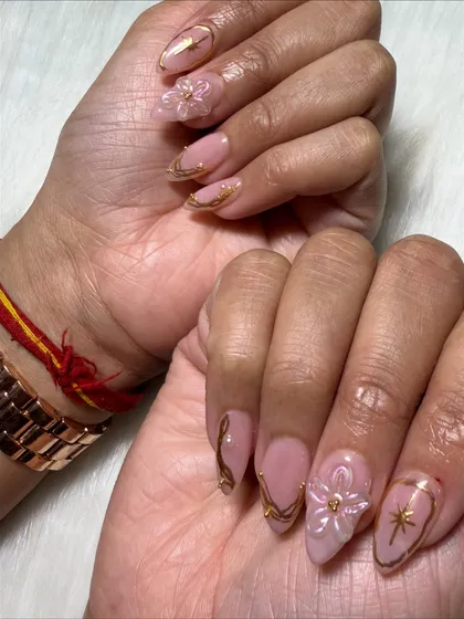 An artistic shot showing the side profile of the 3D flowers and the curve of the nail extensions.
