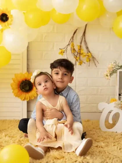 Another adorable portrait of a brother and sister. Including siblings helps make the birthday child feel comfortable and results in beautiful, interactive photos.
