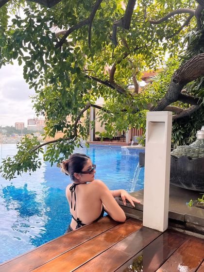 Reset. Restart. Refocus. A shot of me relaxing in a beautiful infinity pool, surrounded by lush greenery. A perfect moment of self-care.