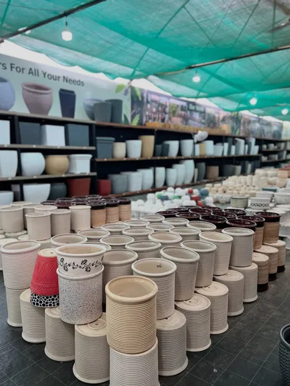 We pride ourselves on offering a huge selection of pots. This aisle shows stacks of terracotta and ceramic pots in different designs, ready for our customers.