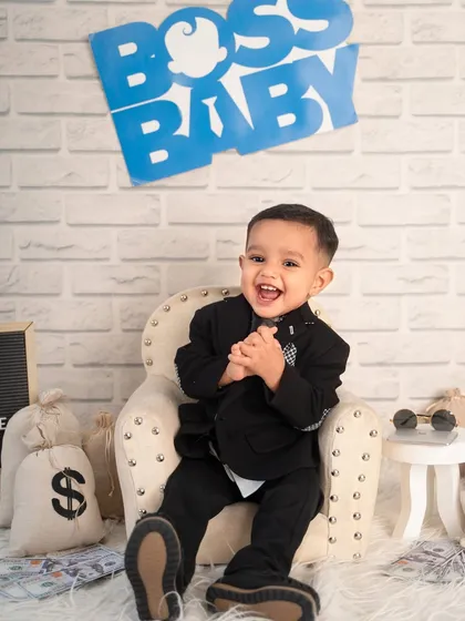 The happiest boss in town! His joyful laugh and excited expression show just how much fun a themed photoshoot can be.