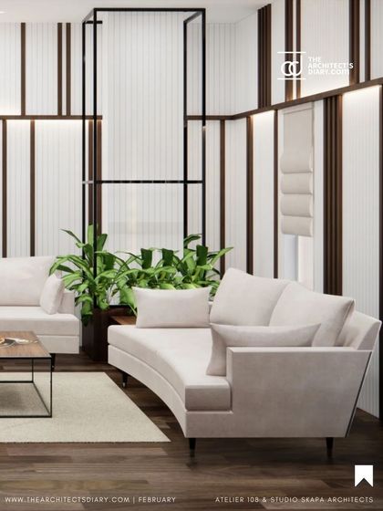 A featured shot of a lounge area in the Meghana Foods office, where we used curved sofas and a mix of white and wood paneling to create a sophisticated yet comfortable space.