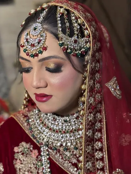 A close-up of bride Sara's eye makeup. The gold glitter on the lids catches the light beautifully, and the defined crease adds depth, making her eyes the centerpiece of the look.