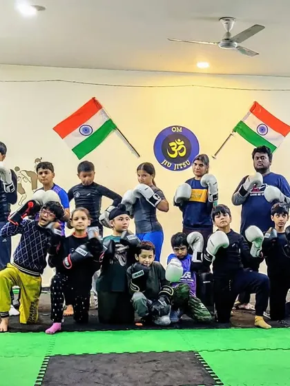 The team posing after a Sunday Muay Thai class. We have a great mix of kids and adults, all learning and growing together.