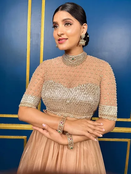 A portrait of Akanksha in the organza and gotta patti ensemble, showing the high-neck illusion blouse design.