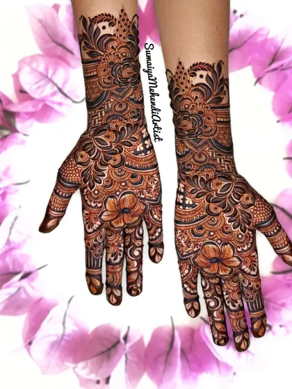 This is a beautiful example of a full and festive design, perfect for a sangeet or as a wedding guest. The mix of flowers and traditional motifs covers the hands beautifully.