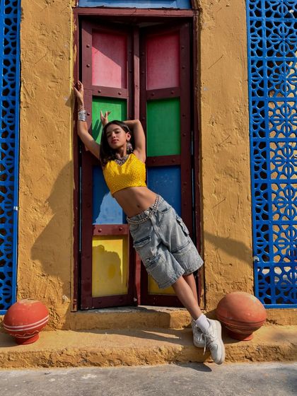 A relaxed pose against a colorful, rustic backdrop. This photo has an Indo-western vibe, showing a different facet of my style.