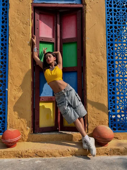 A relaxed pose against a colorful, rustic backdrop. This photo has an Indo-western vibe, showing a different facet of my style.