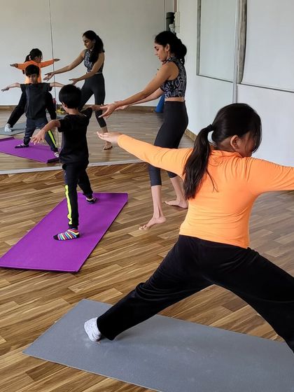 I provide gentle, hands-on adjustments to help my young students understand the alignment of poses like Virabhadrasana II, or warrior II. This ensures they practice safely and effectively.