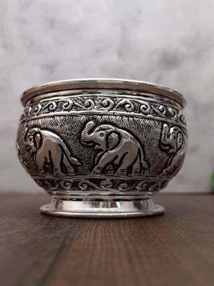 An antique German silver bowl with a procession of elephants carved around its circumference, a very popular and royal design.