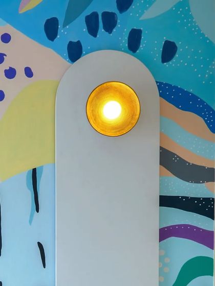 A detail shot of the arched panel with an integrated light, adding a soft, ambient glow against the colorful mural.