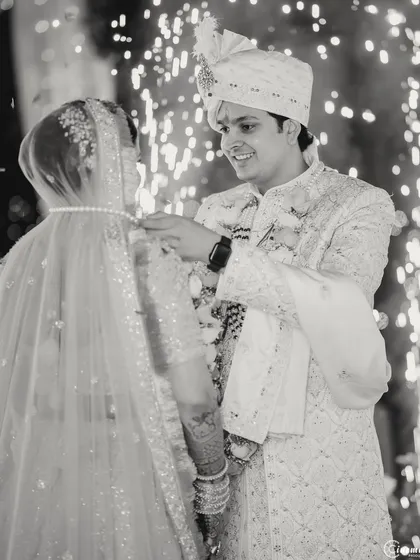 The sacred moment of the groom tying the mangalsutra, captured in classic black and white to emphasize its significance and timelessness.