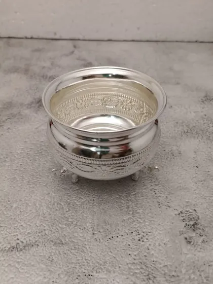A different angle of the elephant leg bowl, showing the smooth finish and the detailed engraving along the rim.